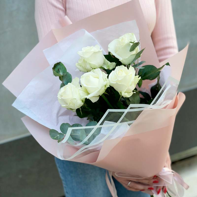 5 white roses in pink packaging photo
