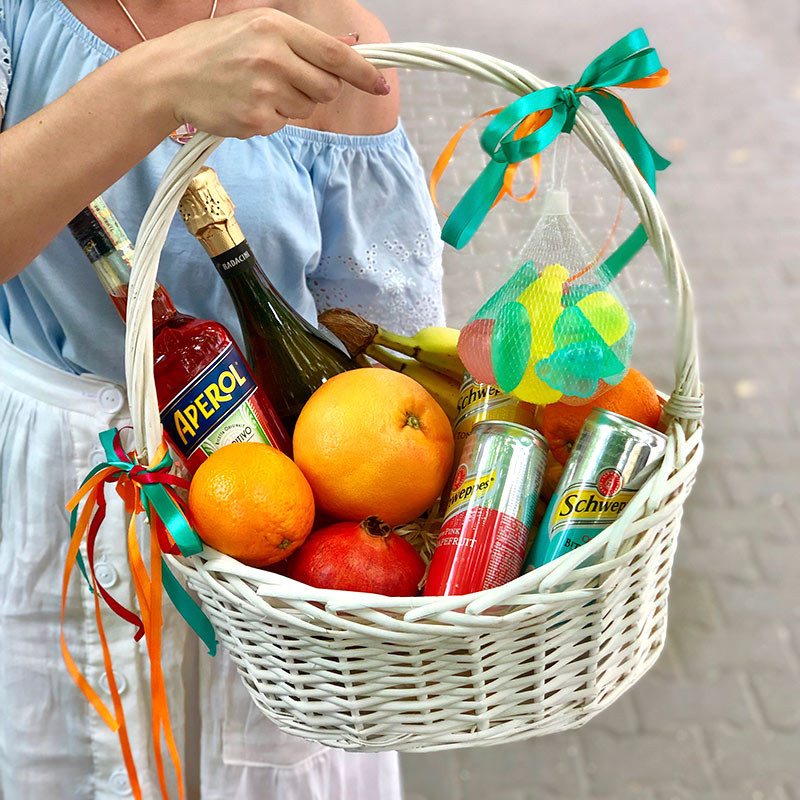 Basket with alcohol and fruit photo